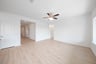 open great room with wood floors and ceiling fan