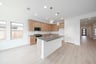 open kitchen with wood floors and island