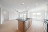 open kitchen with wood floors and island