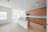 open kitchen with wood floors and island