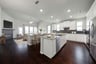 open kitchen with large island and hardwood flooring