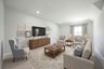 spacious media room with carpet and window