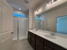 primary bathroom with a shower with a window
