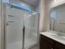 primary bathroom with an oversized shower with a bench