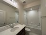 secondary bathroom with a shower and tub combo