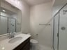 secondary bathroom with a walk-in shower