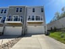 three-story townhome rear exterior with a 2-car garage