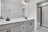 bathroom with gray cabinets and white quartz counters