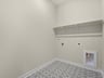 laundry room with pattern flooring and storage space