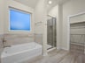primary bathroom with soaking tub and walk in shower