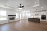 open great room with wood floors and fireplace
