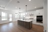  open kitchen with wood floors and island