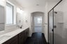 primary bathroom with walk-in shower and tile floors