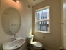 powder room with an oval mirror