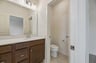 primary bathroom with a toilet room