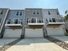 townhome exterior with a 2-car garage and deck