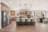 spacious kitchen with brown cabinets and hardwood flooring