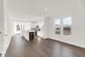 dining area with dark wood plank flooring open to the kitchen