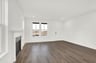 great room with wood plank flooring and windows letting in natural light