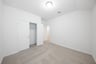 guest bedroom with carpet and closet 