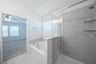 bathroom with tub and shower