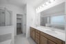 bathroom with brown cabinets and two sinks 