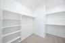 closet with shelves and hanging racks 