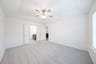 primary bedroom with carpet and ceiling fan
