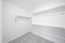 primary closet with carpet and white shelves