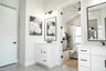 bath with white cabinet vanities and mirrors