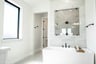 bath with white tub and window