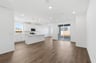 great room with wood floors, white walls, recessed ceiling lights, and sliding glass door to back patio