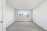bedroom with tan carpet, white walls, recessed ceiling lights, and two windows