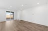 great room with wood floors, white walls, recessed ceiling lights, and sliding glass door to back covered patio