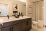 secondary bathroom with dual vanities