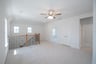 open gameroom with carpet and ceiling fan
