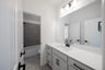 bathroom with white countertops and tile flooring