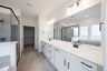 bathroom with white countertops and two sinks 