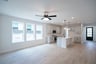 open great room with wood floors and ceiling fan