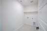 laundry room with tile floors and white shelf