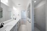 primary bathroom with walk-in shower and cabinets