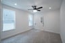 primary bedroom with carpet and ceiling fan