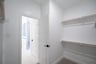 primary bedroom closet with carpet and white shelves