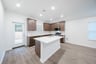 open kitchen with wood floors and island