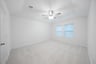 primary bedroom with carpet and ceiling fan