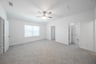 open gameroom with carpet and ceiling fan