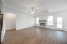 open great room with wood floors and fireplace