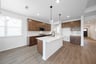 open kitchen with wood floors and island