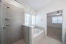primary bathroom with soaking tub and walk-in shower