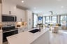 white kitchen overlooks the open great room
